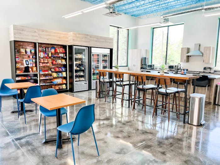 Image of corporate breakroom with chairs and vending machines