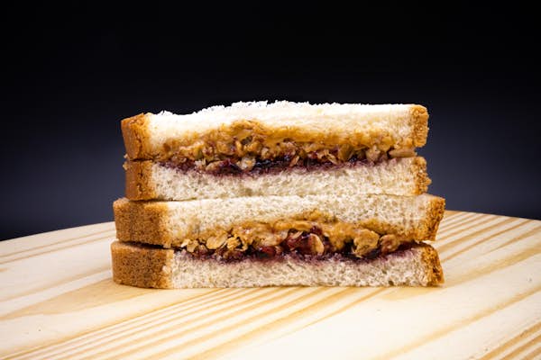 PB&J sandwich on a wood block