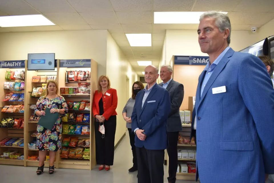 Corporate employees standing in breakroom
