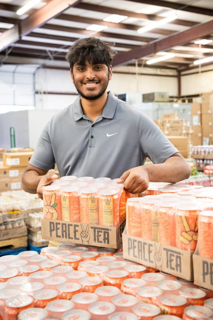 Employee holding a crate of Peace Tea