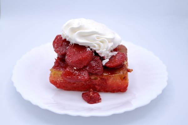 Strawberry shortcake on a plate with whip cream