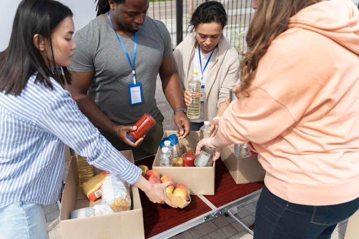Four employees volunteering at food bank